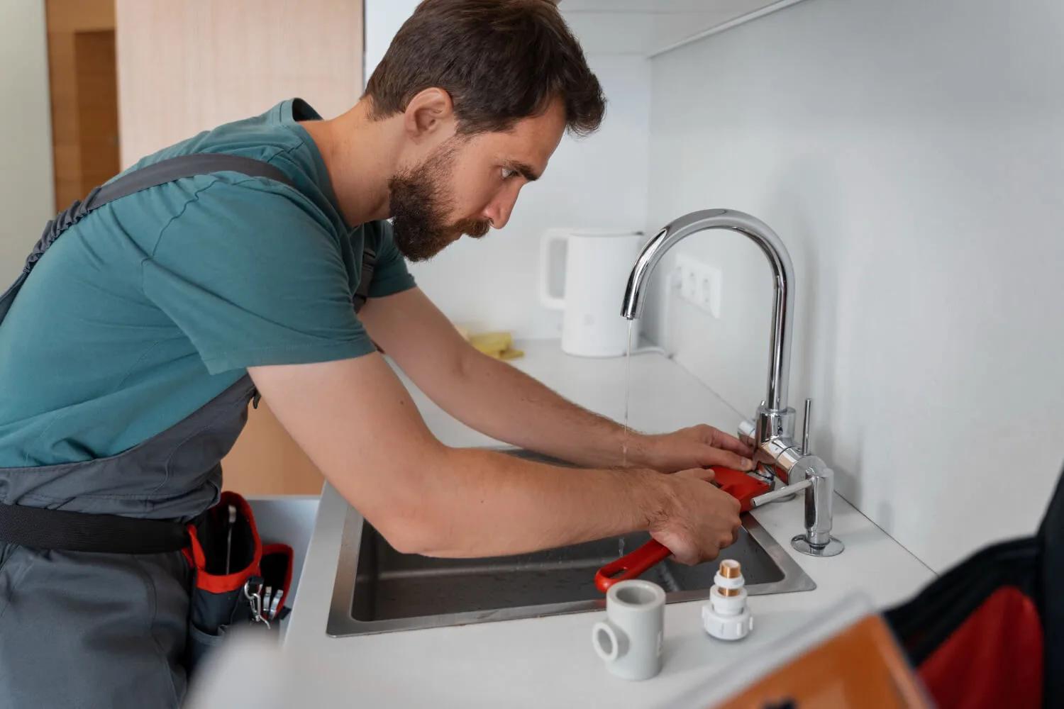 Plumber repairing a leaking tap and shower pipework in Mansfield
